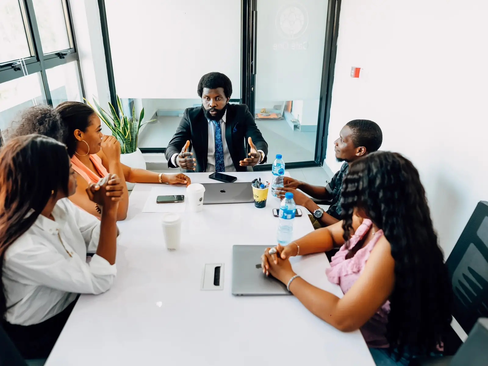 Business team in a boardroom meeting (illustrative)